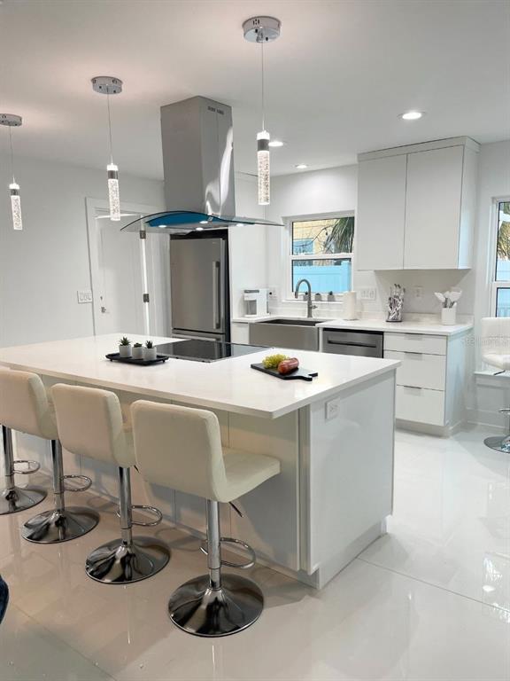 16102 1st Street East Redington Beach, FL 33708 - Photo 8 of 39 a kitchen with stainless steel appliances a sink and a refrigerator