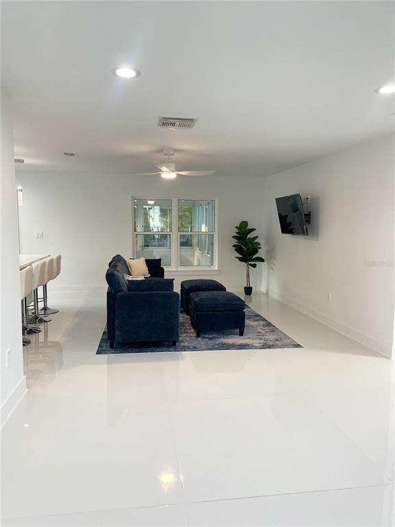 16102 1st Street East Redington Beach, FL 33708 - Photo 10 of 39 a living room with furniture and a flat screen tv