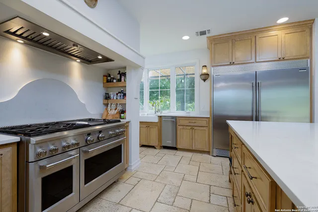 a living room with furniture a ceiling fan and a flat screen tv