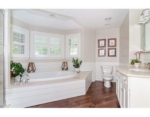 1 Woodridge Road Wellesley, MA 02482 - Photo 16 of 26 a bathroom with a bathtub a sink and a window