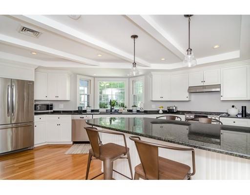 1 Woodridge Road Wellesley, MA 02482 - Photo 5 of 26 a kitchen with a sink a kitchen island and stainless steel appliances