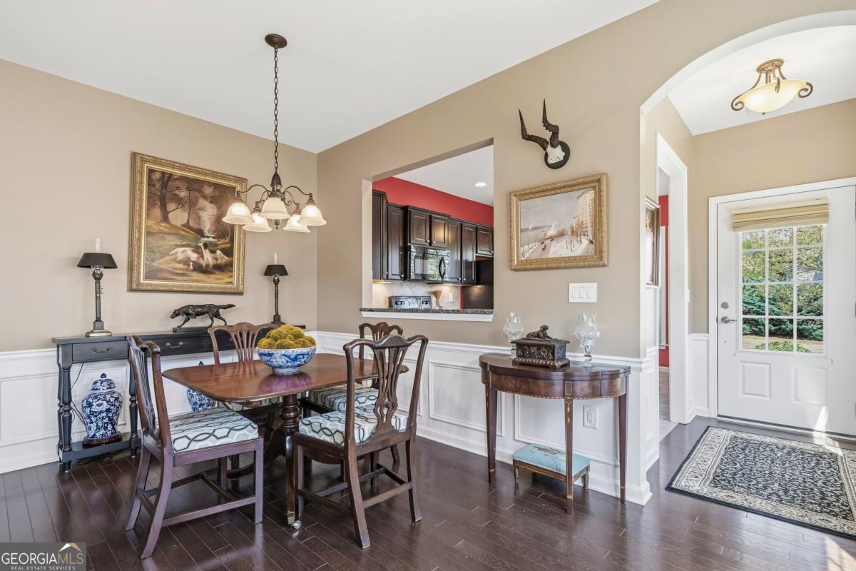 1320 Summer Hollow Road Greensboro, GA 30642 - Photo 15 of 45 a view of a dining room with furniture window and wooden floor