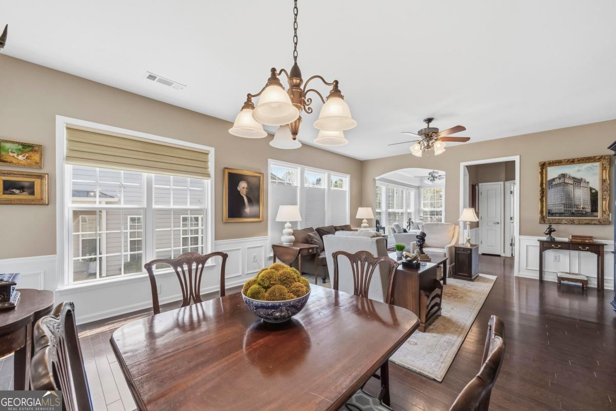 1320 Summer Hollow Road Greensboro, GA 30642 - Photo 16 of 45 a view of a dining room with furniture a chandelier and wooden floor