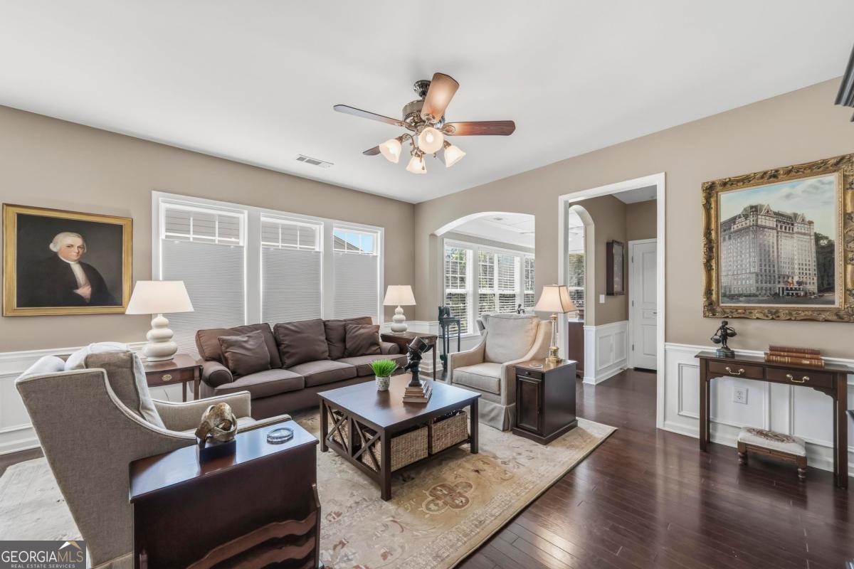 1320 Summer Hollow Road Greensboro, GA 30642 - Photo 17 of 45 a living room with furniture ceiling fan and a wooden floor