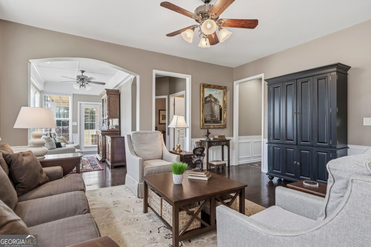 1320 Summer Hollow Road Greensboro, GA 30642 - Photo 18 of 45 a living room with furniture a chandelier and a dining table