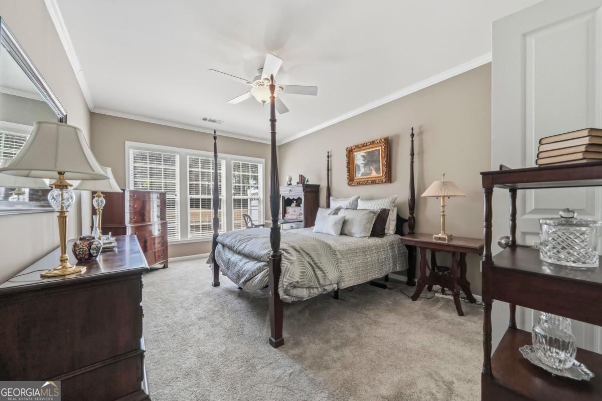 1320 Summer Hollow Road Greensboro, GA 30642 - Photo 29 of 45 a spacious bedroom with a bed a couch and large window