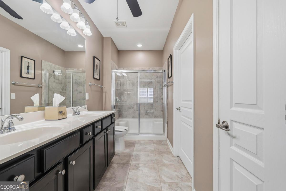 1320 Summer Hollow Road Greensboro, GA 30642 - Photo 32 of 45 a spacious bathroom with a double vanity sink mirror and shower