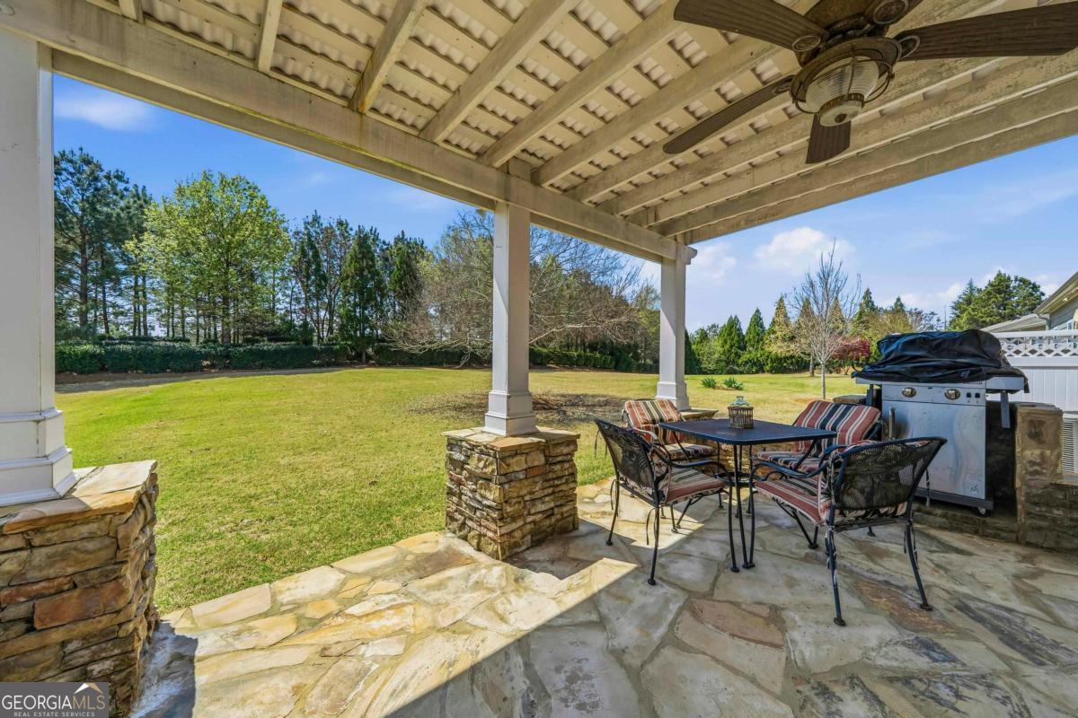 1320 Summer Hollow Road Greensboro, GA 30642 - Photo 39 of 45 a view of a patio with a table chairs and a table