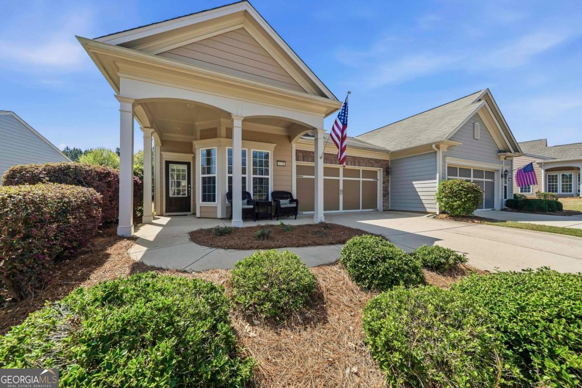 1320 Summer Hollow Road Greensboro, GA 30642 - Photo 4 of 45 a front view of a house with a yard outdoor seating and garage