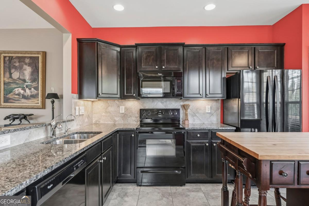 1320 Summer Hollow Road Greensboro, GA 30642 - Photo 8 of 45 a kitchen with a sink stove and refrigerator