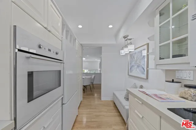 a hallway with cabinets a washer and dryer