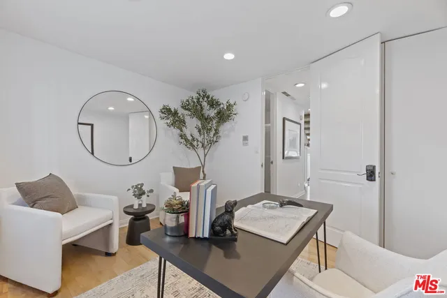 a living room with furniture and a mirror