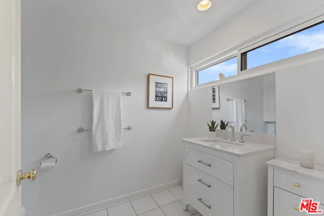 a bathroom with a sink vanity and a mirror
