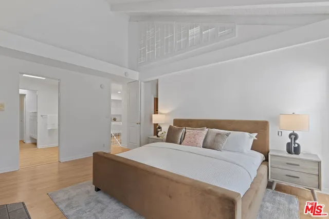 a bedroom with a bed and a walk in closet