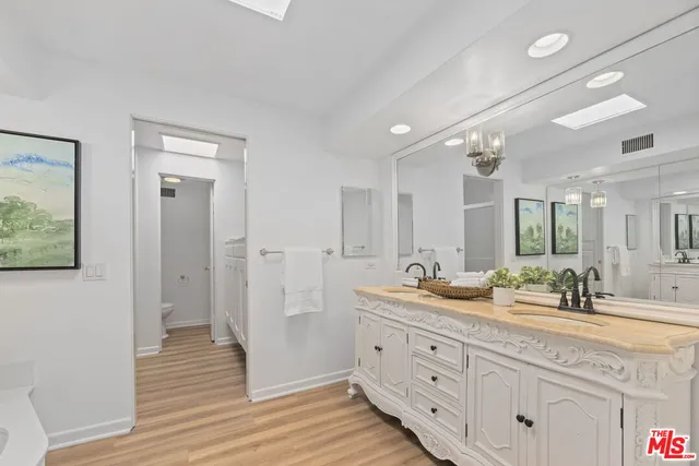 a bathroom with double vanity sink and mirror