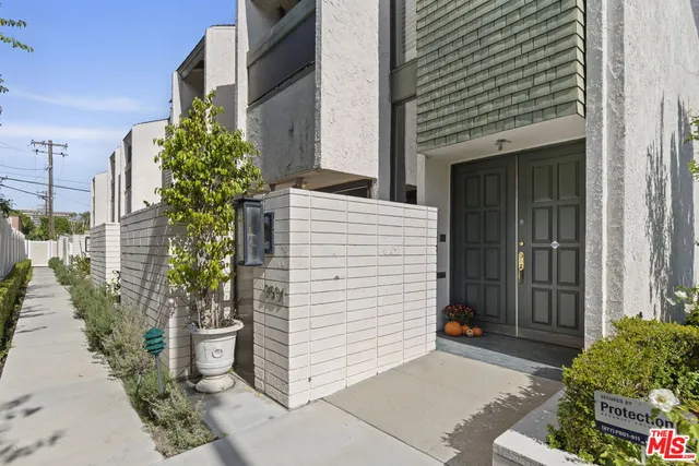 a view of a house with a potted plant and a garage