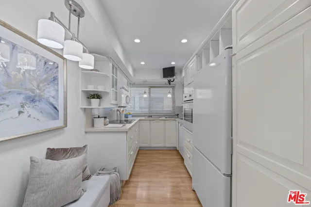 a kitchen with stainless steel appliances kitchen island granite countertop a refrigerator and a stove