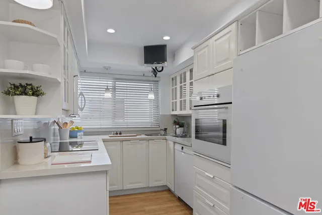 a kitchen with a sink cabinets and window