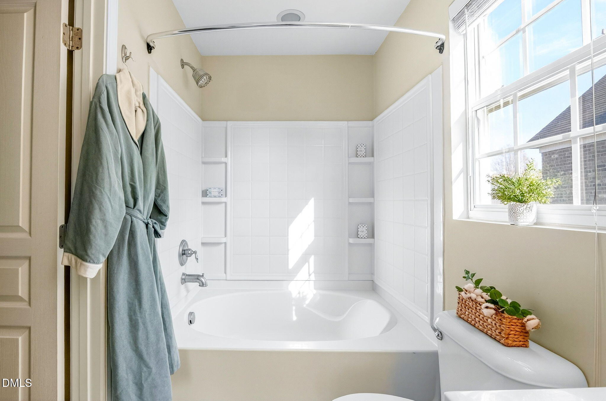 603 Cupola Drive Raleigh, NC 27603 - Photo 25 of 32 a bathroom with a sink a mirror and a shower