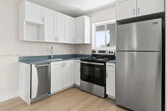 a white refrigerator freezer sitting inside of a kitchen