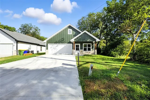 a house with huge green field in front of it