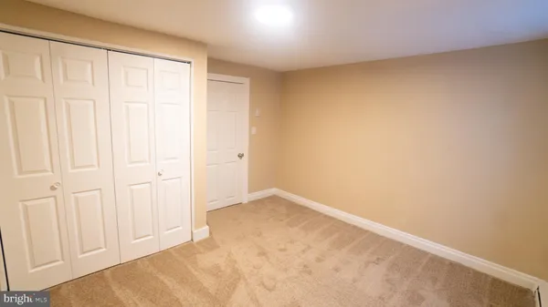 an empty room with a wooden cupboard