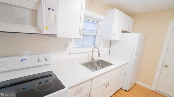 a kitchen with a sink a stove and refrigerator