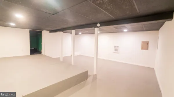 a view of empty room with wooden walls