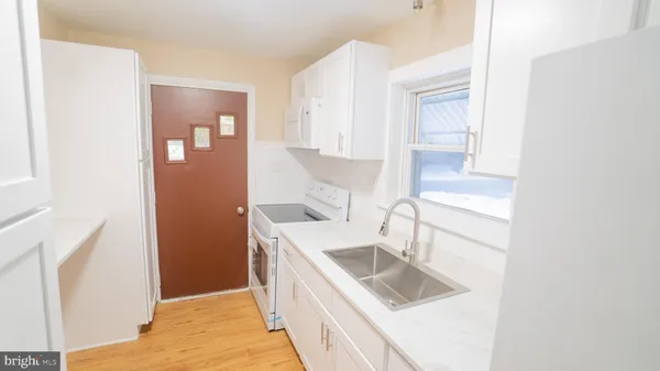 a kitchen with a sink stove and refrigerator