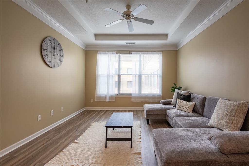 400 17th Street Northwest, Unit 1453 Atlanta, GA 30363 - Photo 11 of 27 a living room with furniture a clock and a window