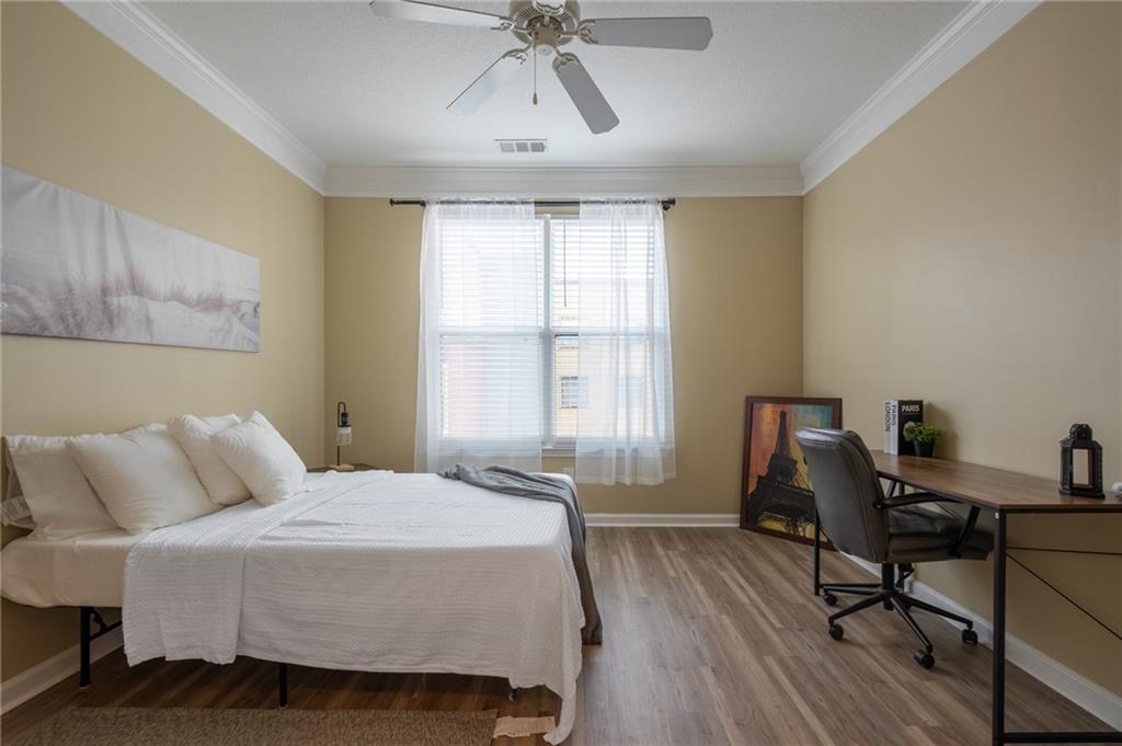 400 17th Street Northwest, Unit 1453 Atlanta, GA 30363 - Photo 16 of 27 a bedroom with a bed and a window