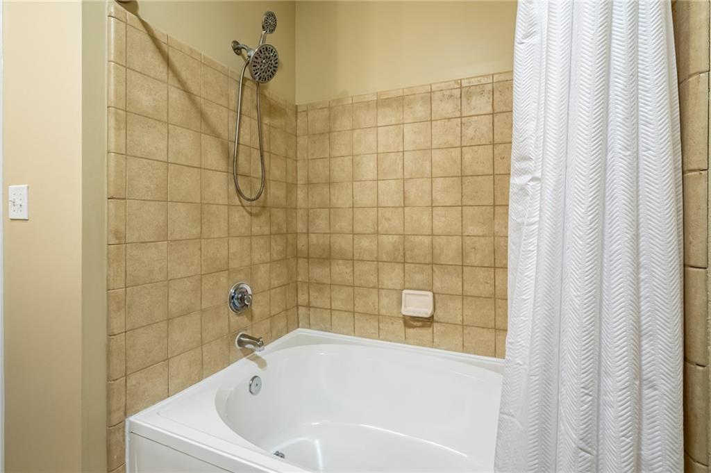 400 17th Street Northwest, Unit 1453 Atlanta, GA 30363 - Photo 20 of 27 a bathroom with a white bath tub and shower