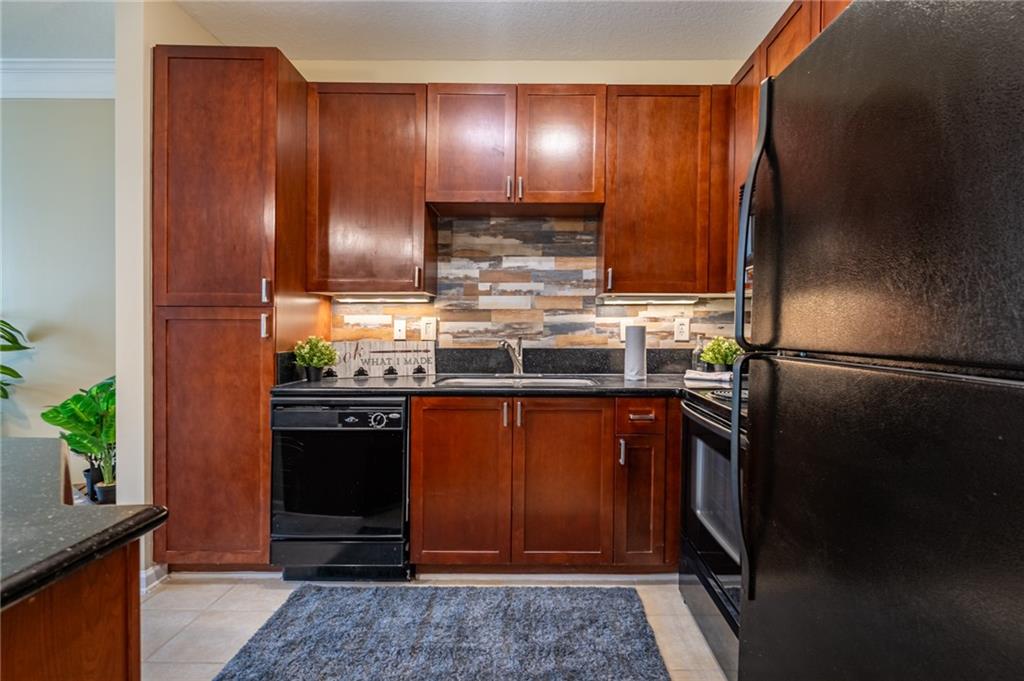 400 17th Street Northwest, Unit 1453 Atlanta, GA 30363 - Photo 2 of 27 a kitchen with stainless steel appliances granite countertop wooden cabinets and a counter top space