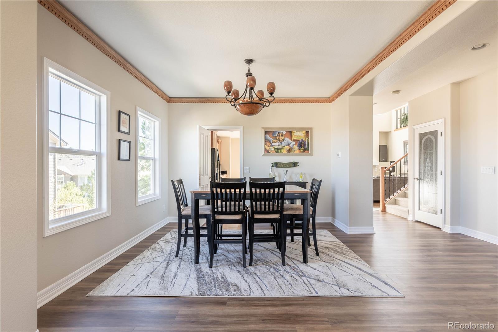1610 Ridgetrail Court Castle Rock, CO 80104 - Photo 12 of 50 a view of a dining room with furniture window and wooden floor