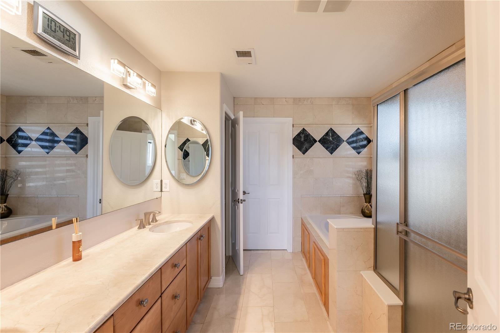 1610 Ridgetrail Court Castle Rock, CO 80104 - Photo 21 of 50 a bathroom with a double vanity sink mirror and bathtub