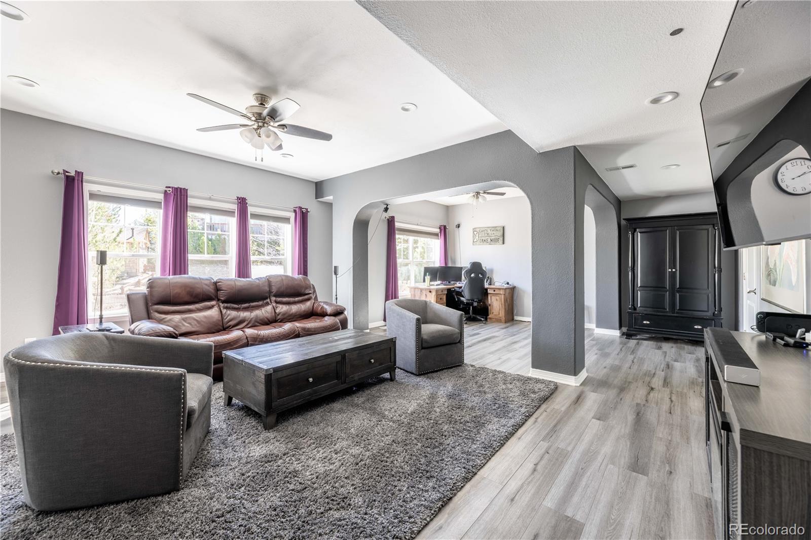 1610 Ridgetrail Court Castle Rock, CO 80104 - Photo 29 of 50 a living room with furniture a fireplace and a flat screen tv