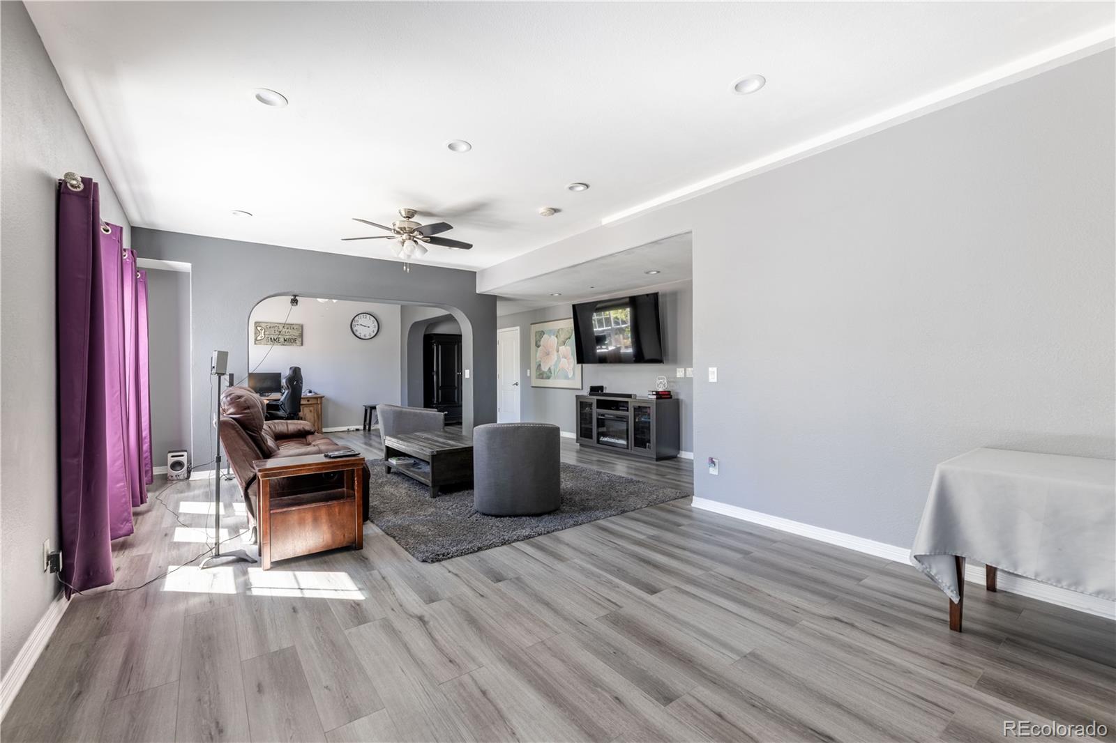 1610 Ridgetrail Court Castle Rock, CO 80104 - Photo 30 of 50 a view of a livingroom with furniture and a ceiling fan