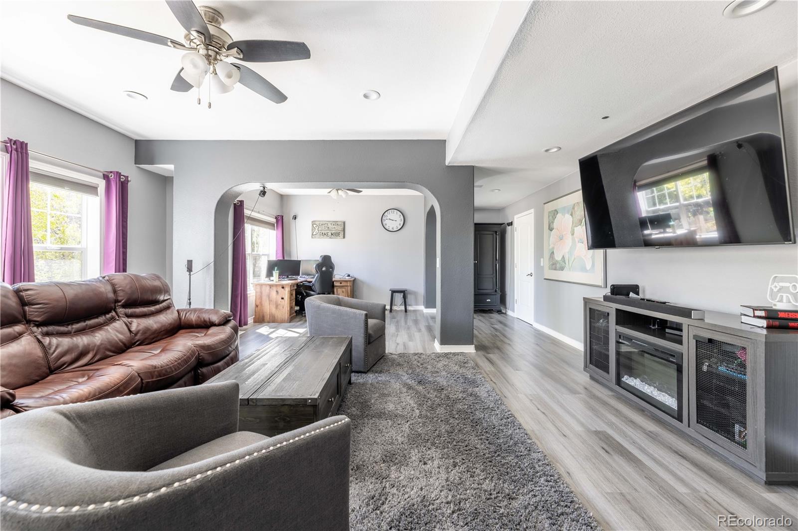1610 Ridgetrail Court Castle Rock, CO 80104 - Photo 31 of 50 a living room with furniture and a flat screen tv