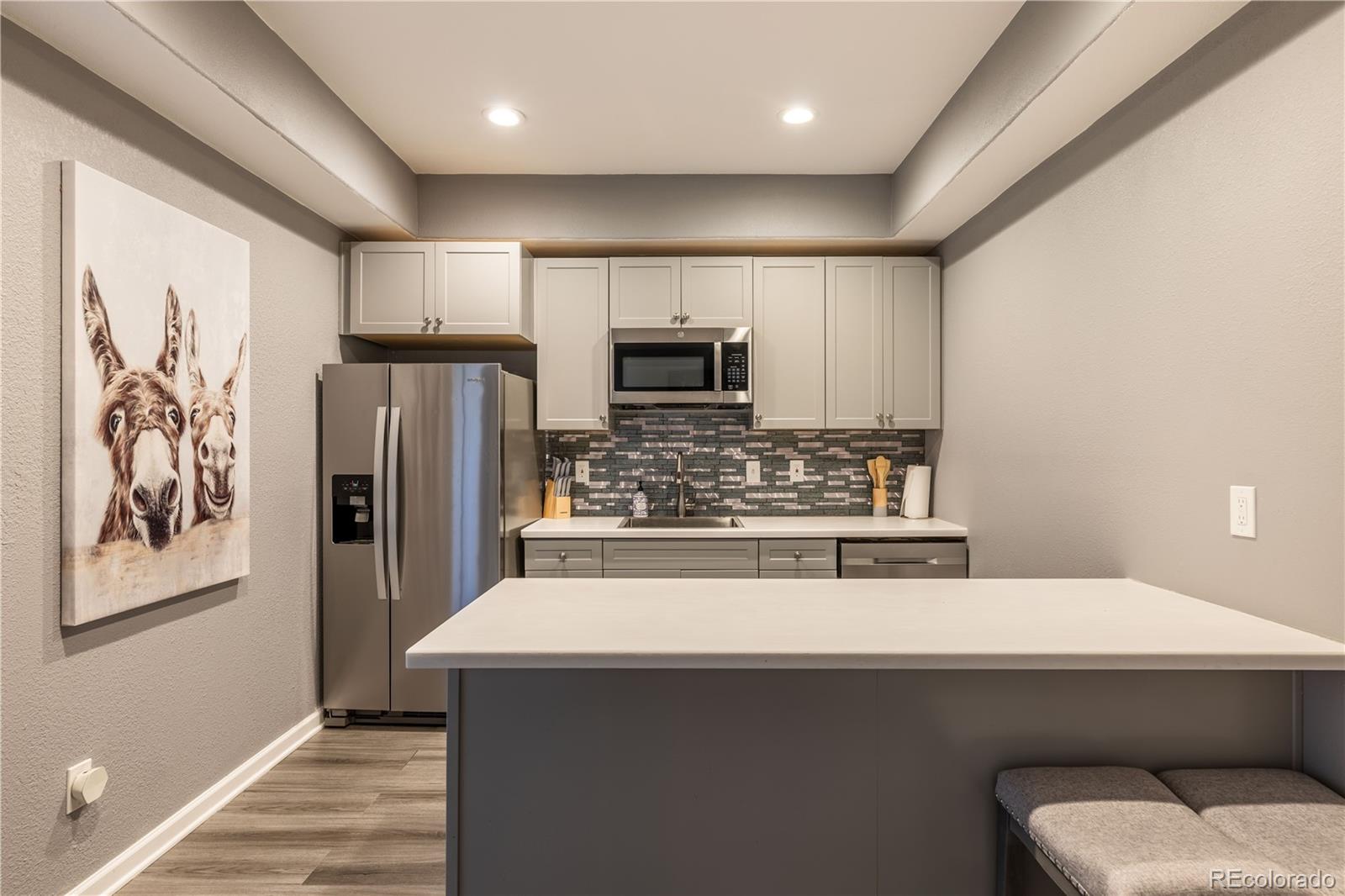 1610 Ridgetrail Court Castle Rock, CO 80104 - Photo 35 of 50 a kitchen with a sink a refrigerator and cabinets