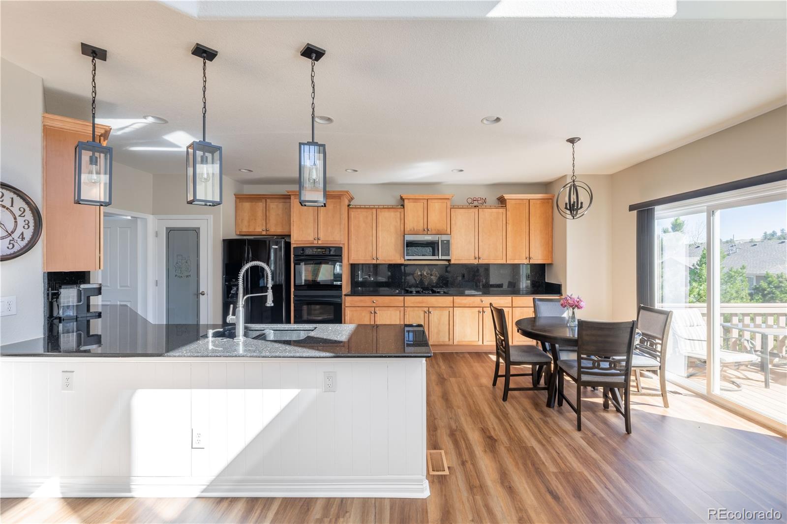 1610 Ridgetrail Court Castle Rock, CO 80104 - Photo 4 of 50 a view of kitchen and dining room with wooden floor