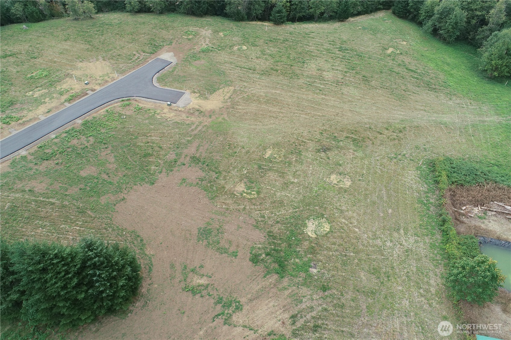 124 Norms Place Ariel, WA 98603 - Photo 3 of 9 a view of a dry yard with lots of green space