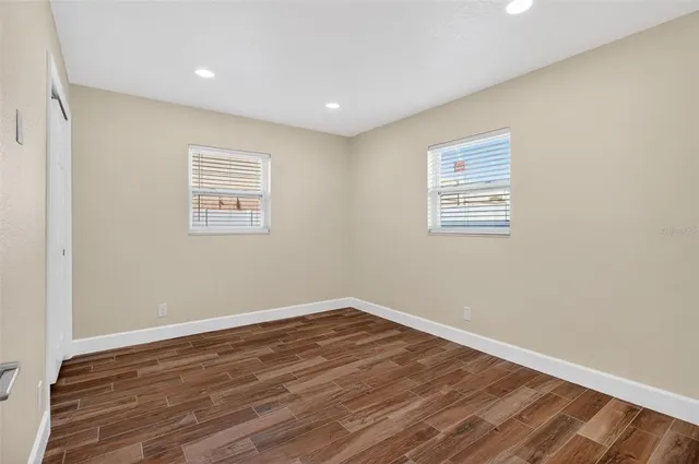 a view of a room with wooden floor and window