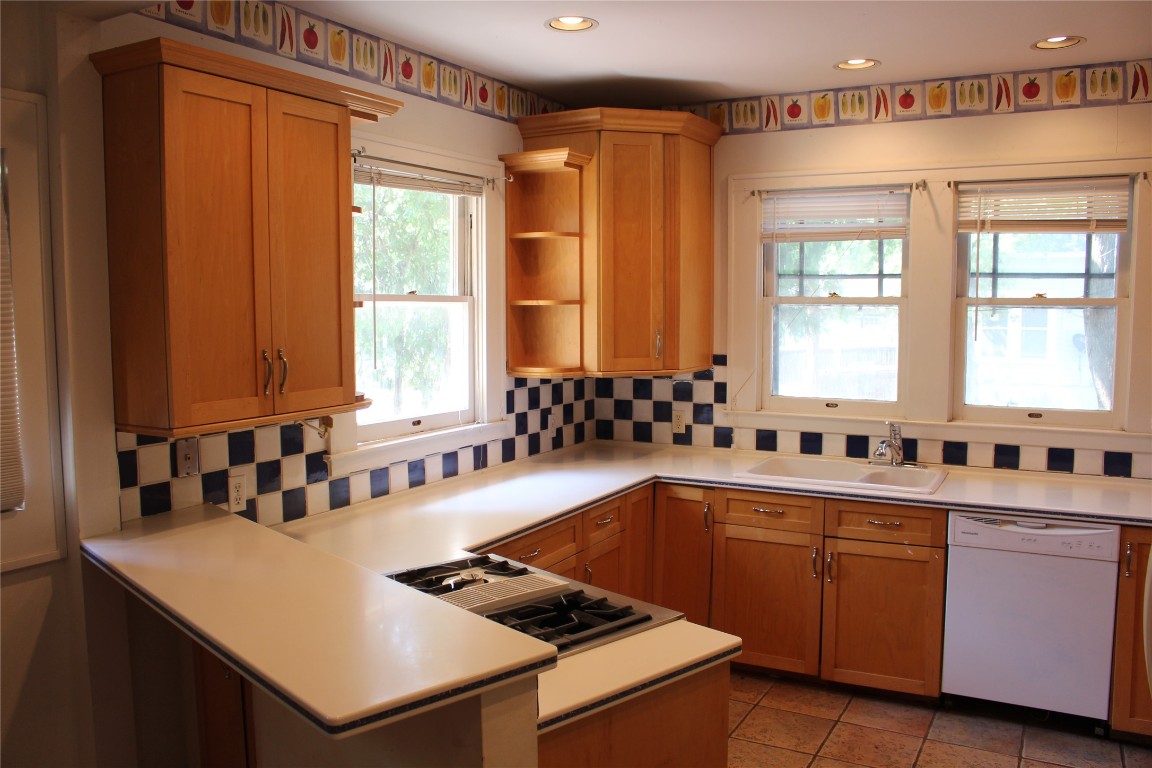 2826 Salado Street Austin, TX 78705 - Photo 12 of 29 a kitchen that has a sink a stove and a table in it
