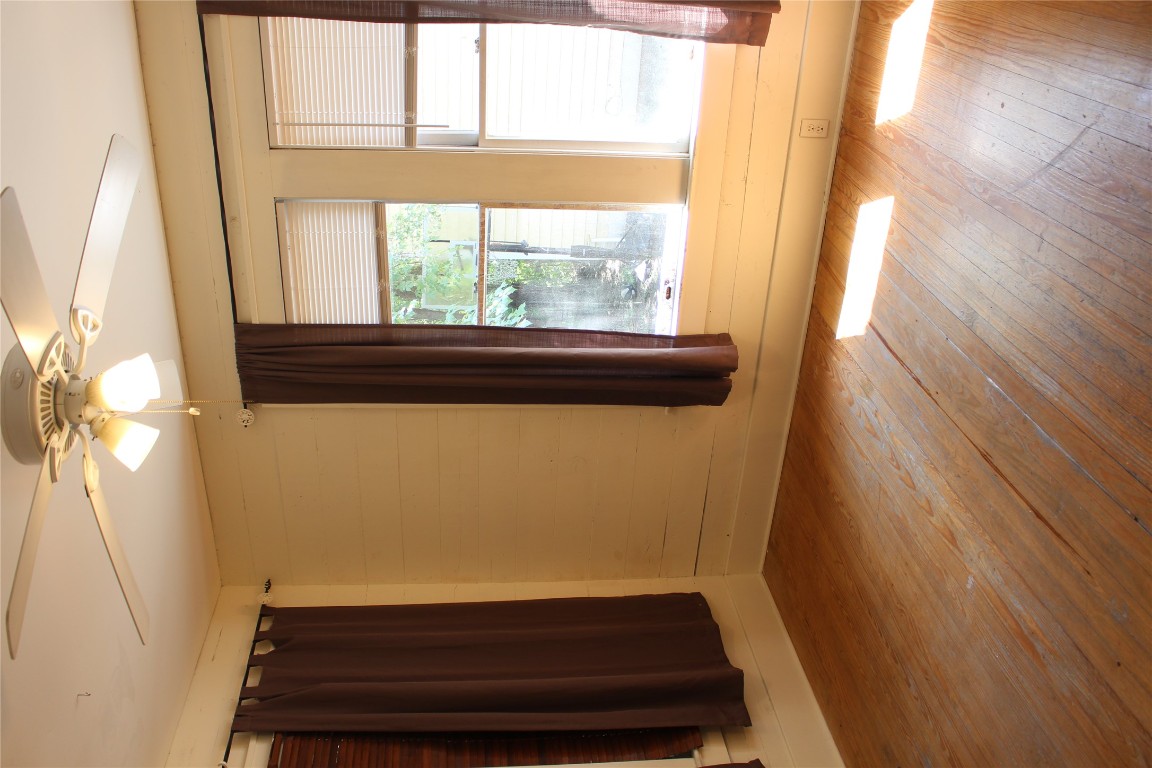 2826 Salado Street Austin, TX 78705 - Photo 18 of 29 a view of an empty room with wooden floor and a window