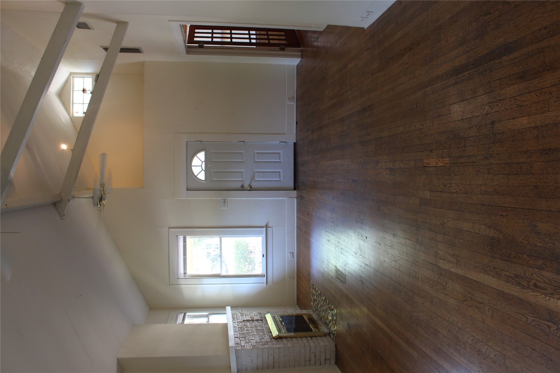 2826 Salado Street Austin, TX 78705 - Photo 19 of 29 an empty room with wooden floor and windows