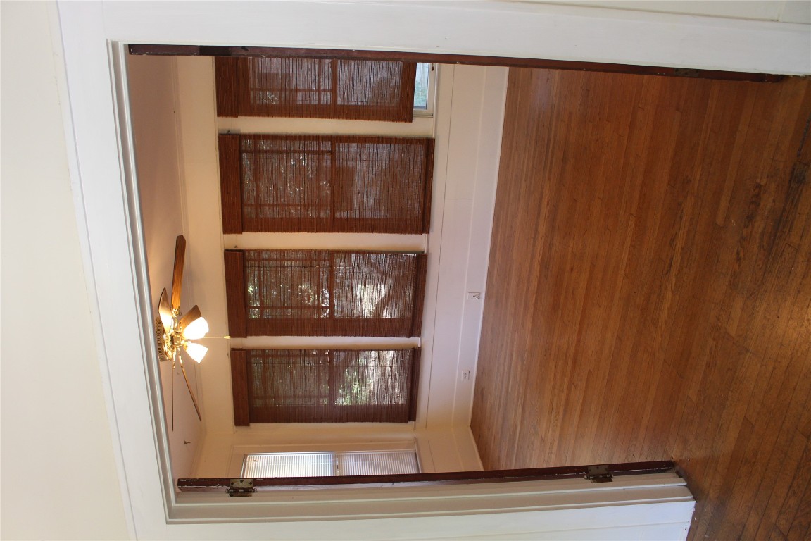 2826 Salado Street Austin, TX 78705 - Photo 21 of 29 a view of an empty room with wooden floor and a window