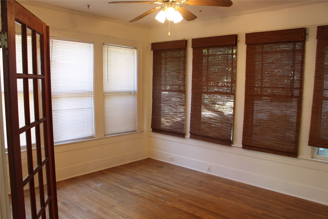 2826 Salado Street Austin, TX 78705 - Photo 22 of 29 an empty room with wooden floor and windows
