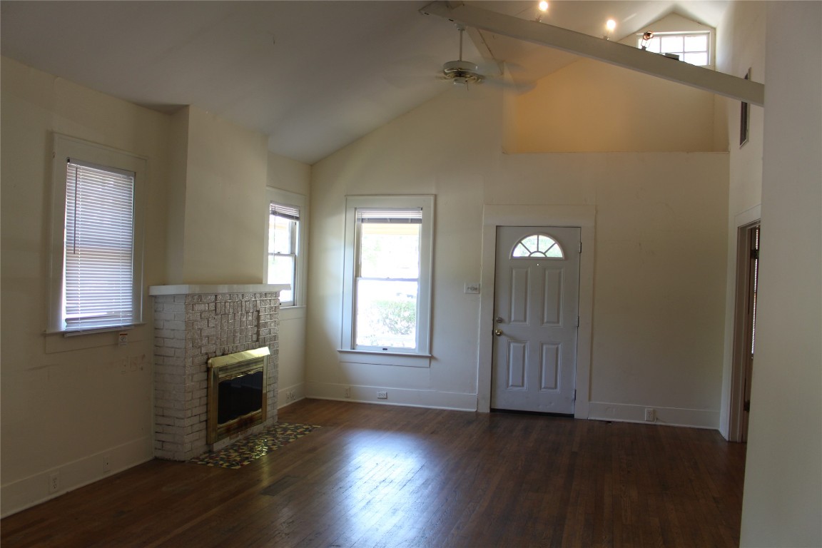 2826 Salado Street Austin, TX 78705 - Photo 10 of 29 an empty room with wooden floor cabinet and windows