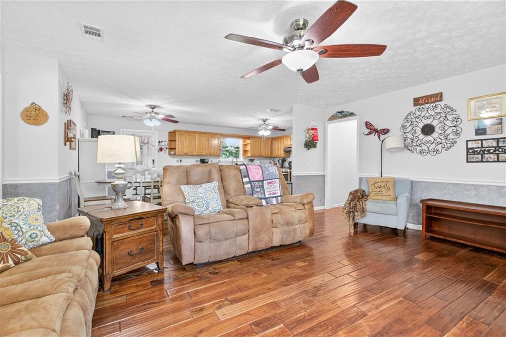 3771 Castleberry Road Cumming, GA 30040 - Photo 12 of 69 a living room with furniture and a wooden floor