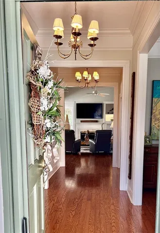 a view of living room filled with furniture and chandelier